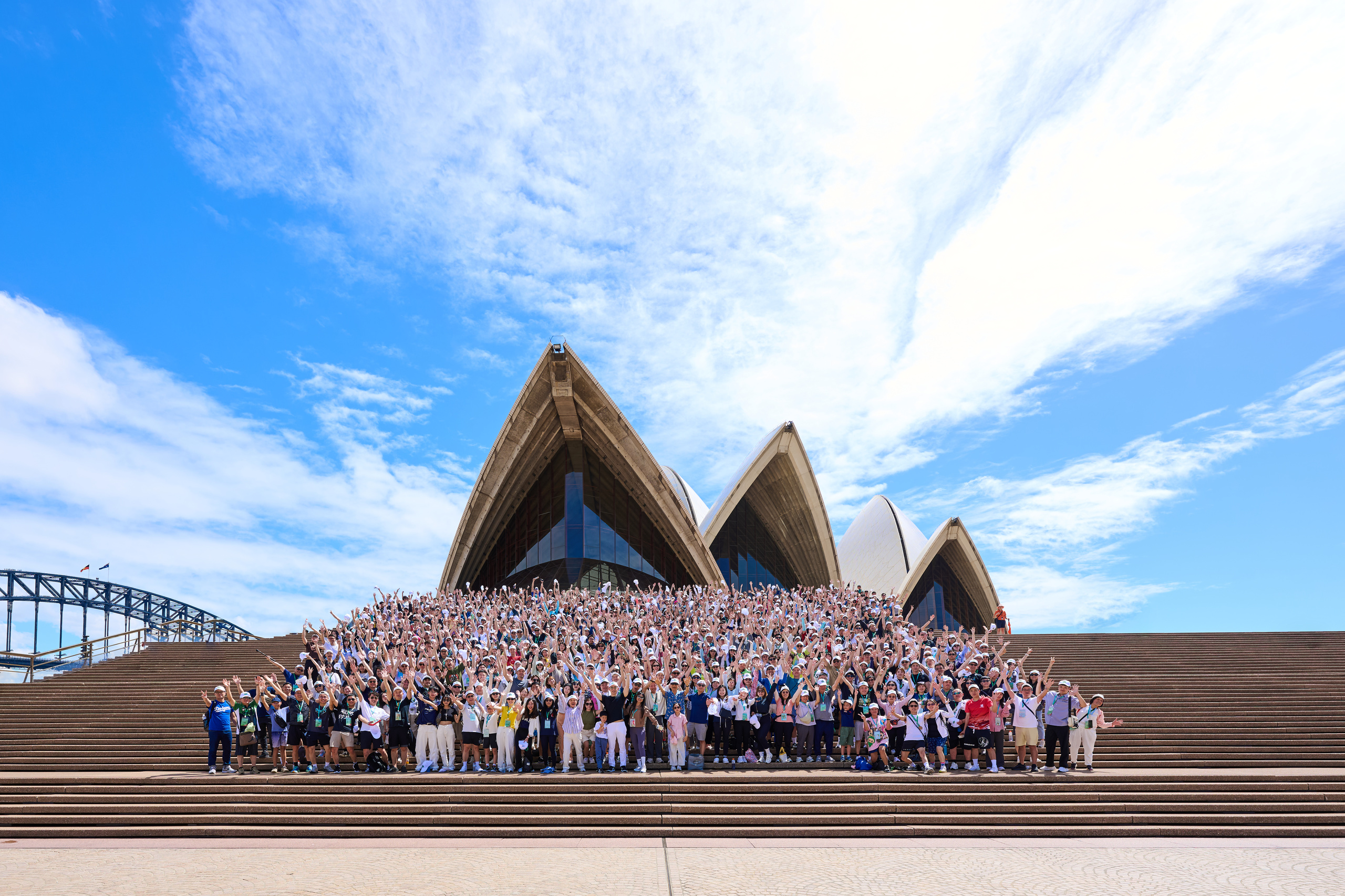 Large Group Photo of 1200 people professionally arranged in the Sydney Opera House Forecourt Stairs. Photo By Orlandosydney.com